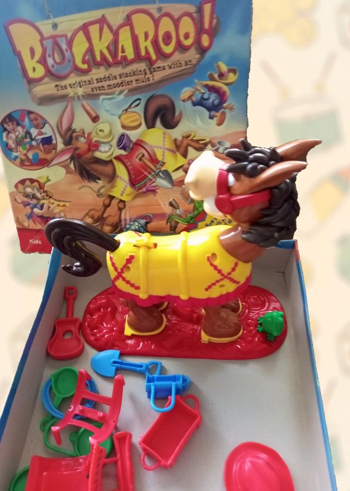 Buckaroo! is a beloved game that has entertained children for generations. This pre-loved version is in excellent condition and includes all the pieces you need to start playing. Help Buckaroo the horse stay upright as you carefully stack saddles, bridles, and other accessories on his back. It is a fun and challenging game that will test your child balance, coordination, and patience.

Perfect for: Kids ages 4 and up

Condition: Pre-loved, complete, and in excellent condition

Dont miss out on this opportunity to bring home a piece of childhood nostalgia for your child!